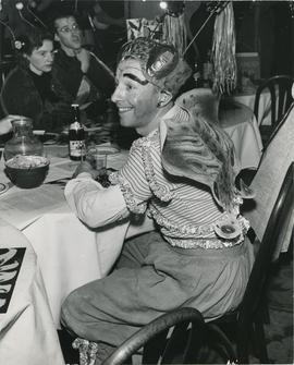 [Attendee in costume at a table at the Fiesta of the Insects Beaux Arts Ball]